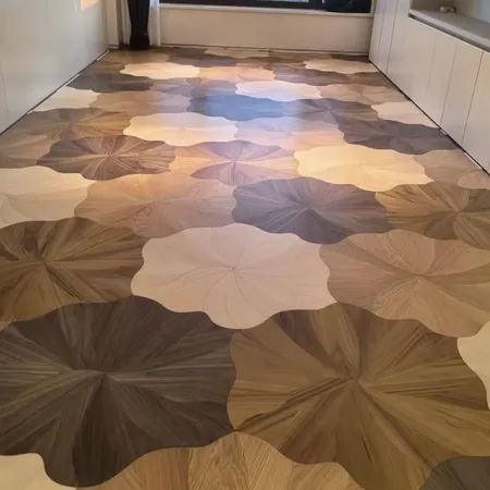 Long hallway floor with large flower-shaped tiles in cream, beige, and brown.