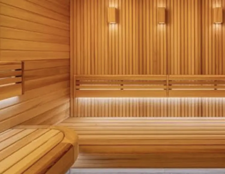 Wooden sauna interior featuring warm lighting